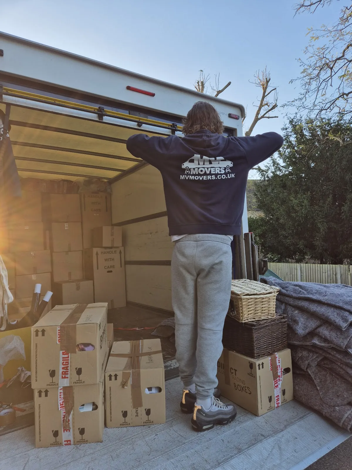MV Movers crew member with packed boxes stacked ready for the van – Packing Service by Dave's MV Movers crew MV Movers crew member with packed boxes stacked ready for the van – Packing Service by Dave's MV Movers crew